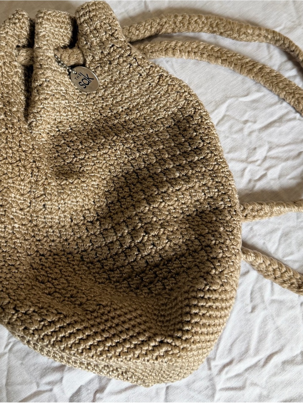 The Sak Crochet Drawstring Backpack in Tan